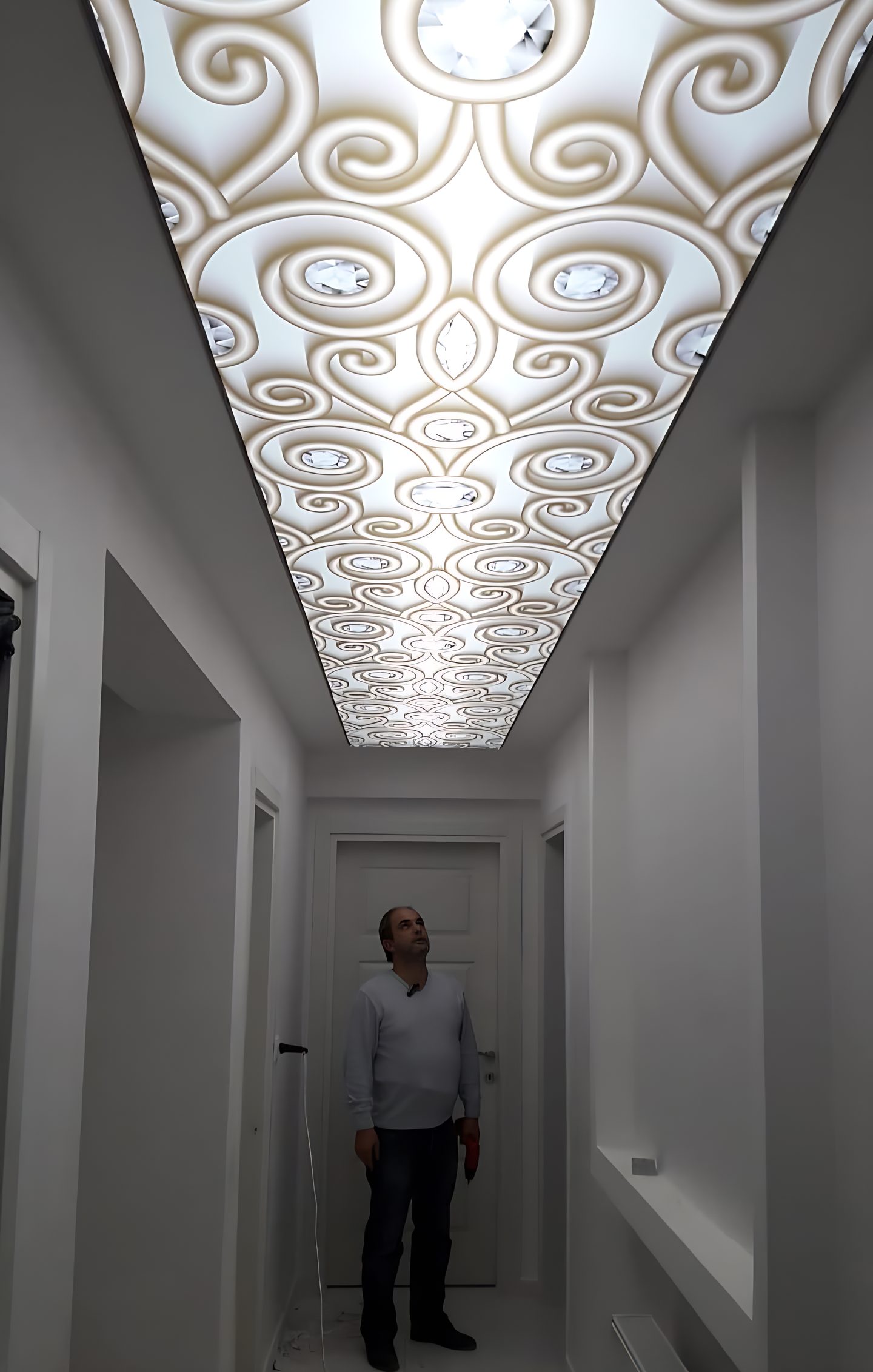 Koridor tavanında arkadan aydınlatılmış süsleme desenli gergi tavan